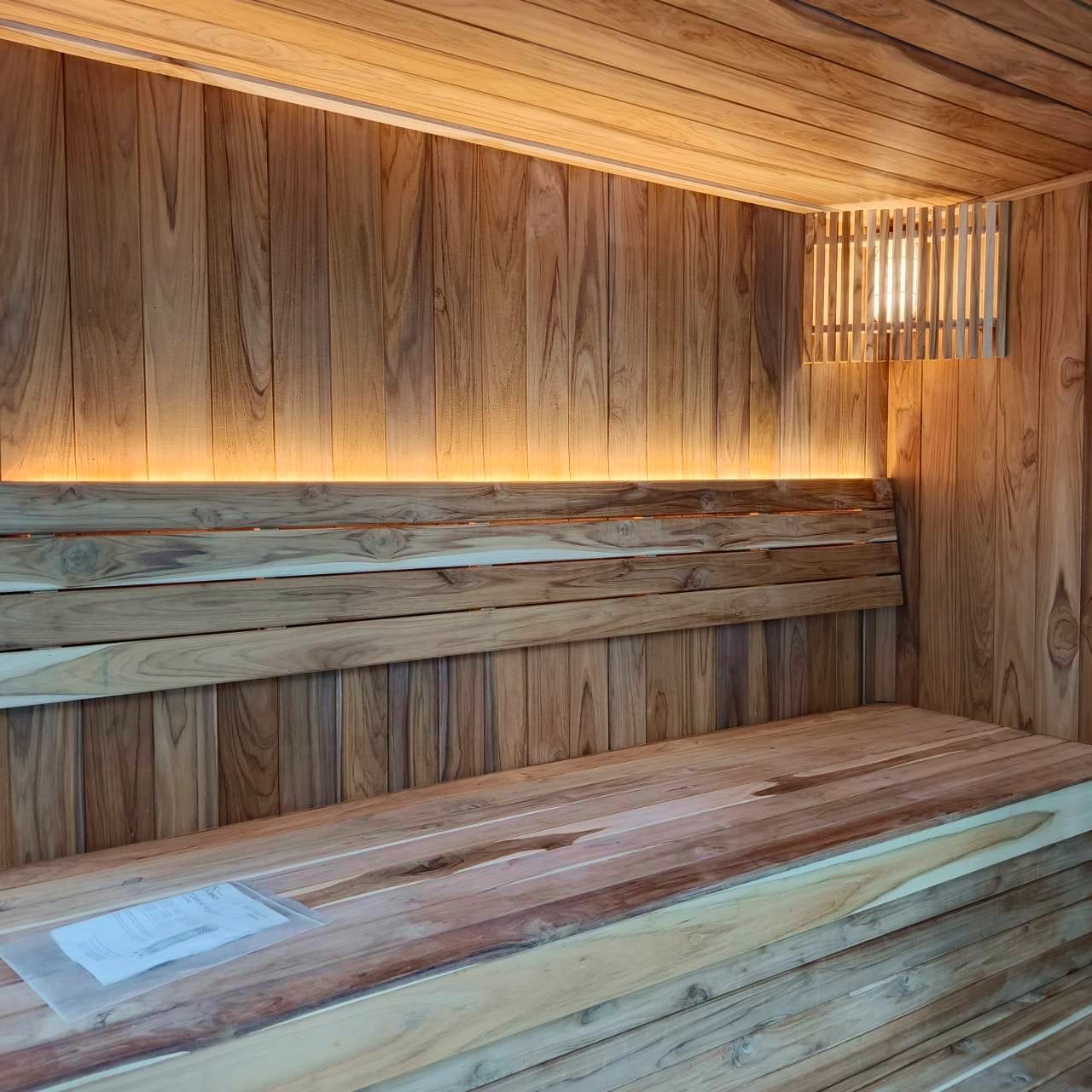 Narak indoor sauna interior with backlit LED ceiling and teak benches