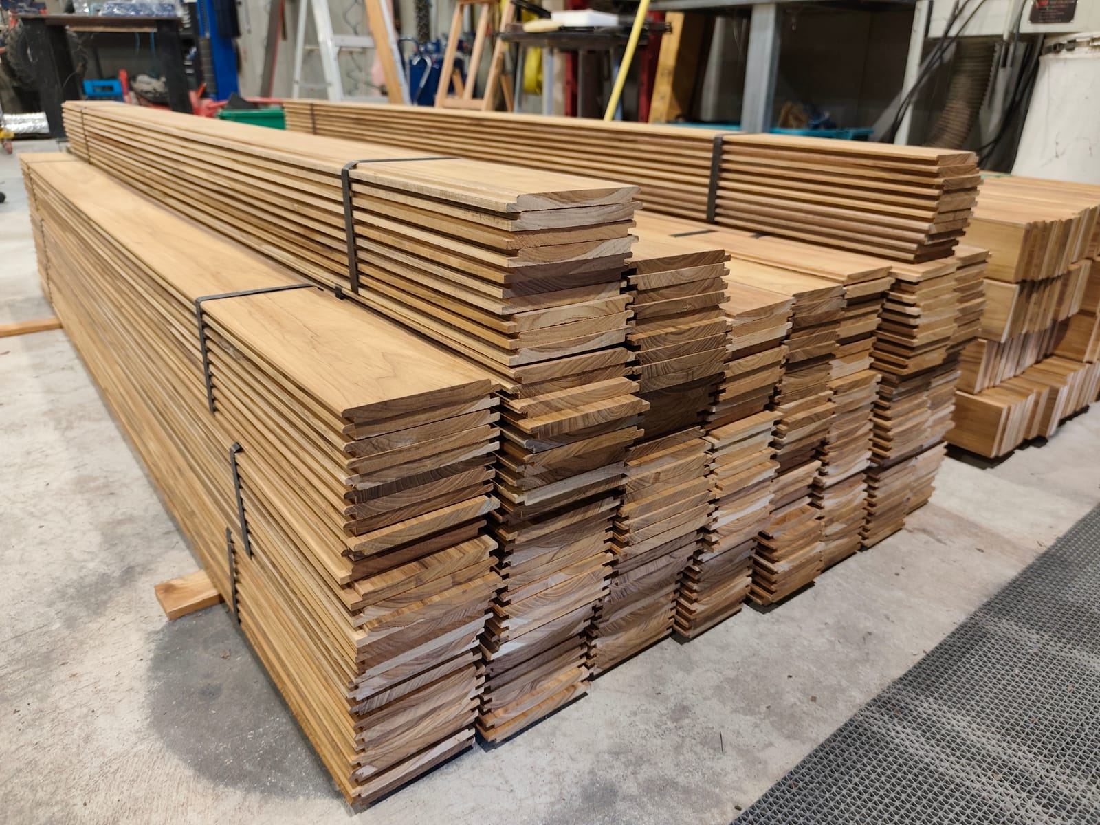 Teak off-cuts stacked and sorted after a sauna build