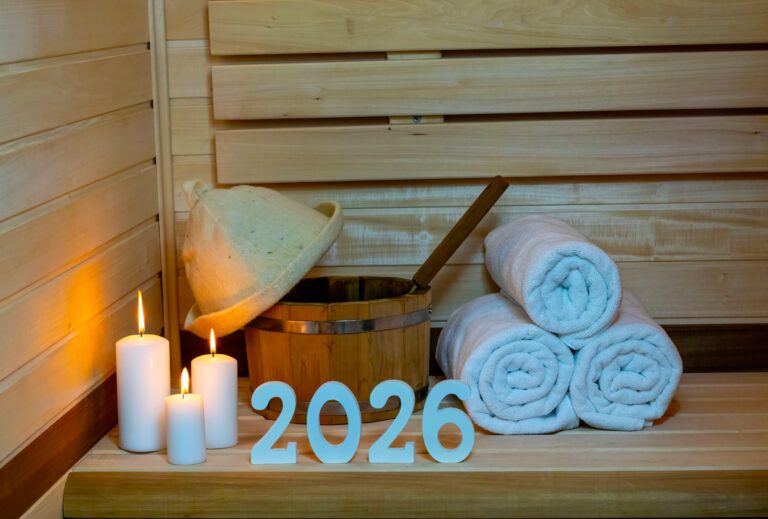 Inside sauna with rolled up towels, bucket and hat